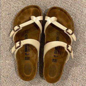 Pearl colored Birkenstock sandals with toe strap